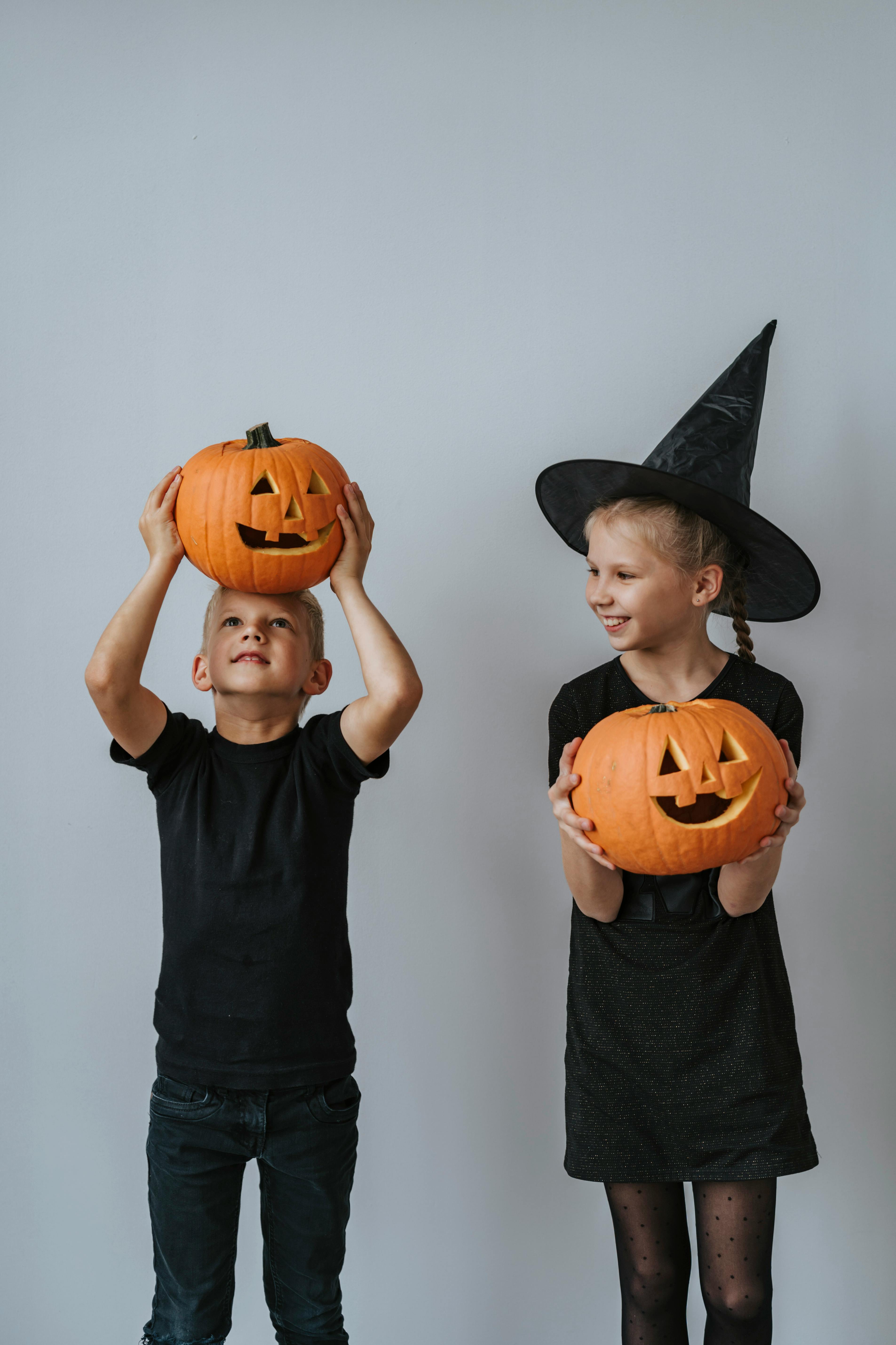 Children holding carved Halloween pumpkins at a school club activity